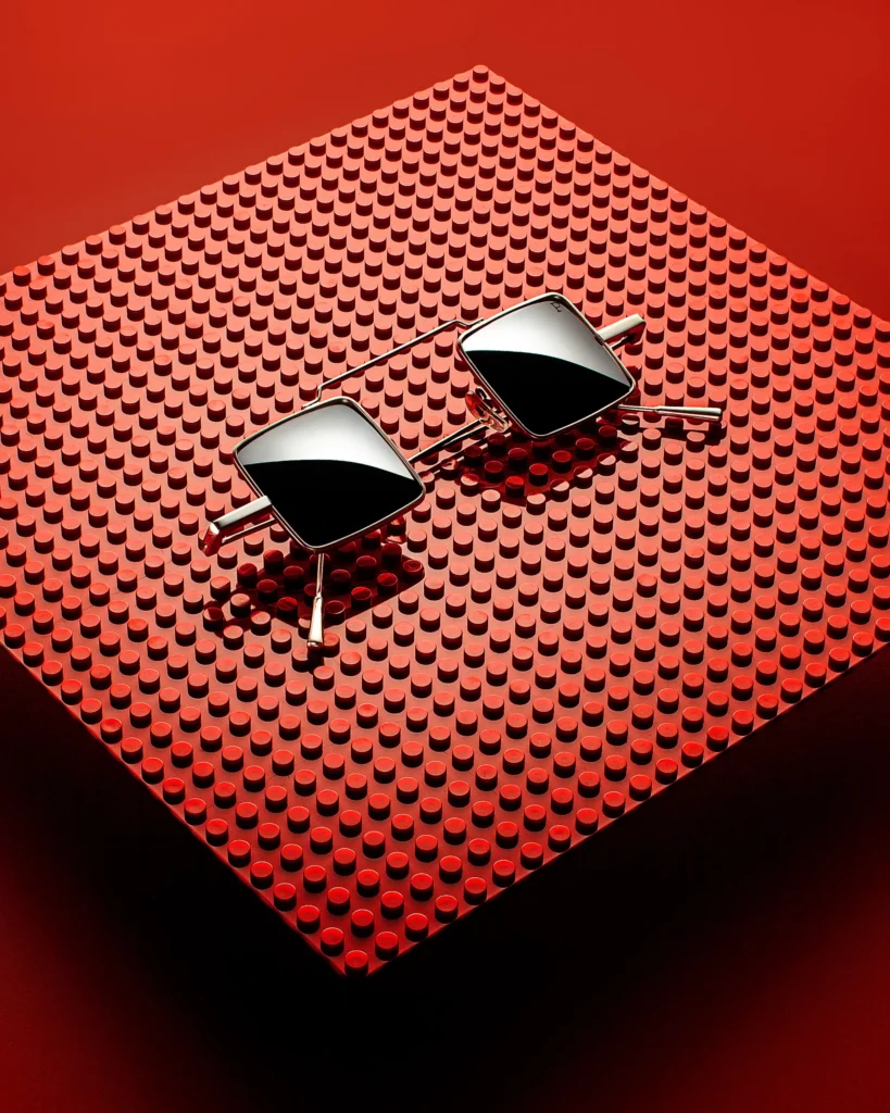 Mirrored square sunglasses on a red studded panel