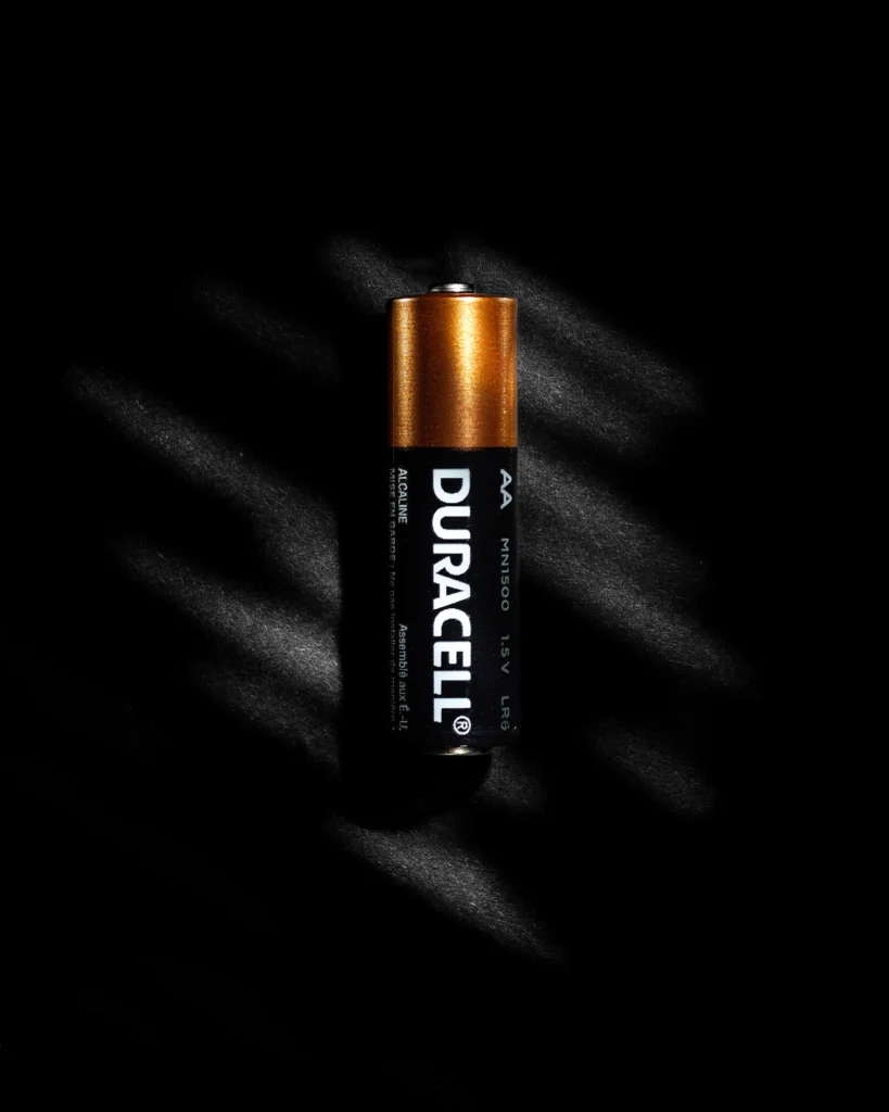 Alkaline battery lit by a shaft of light on black