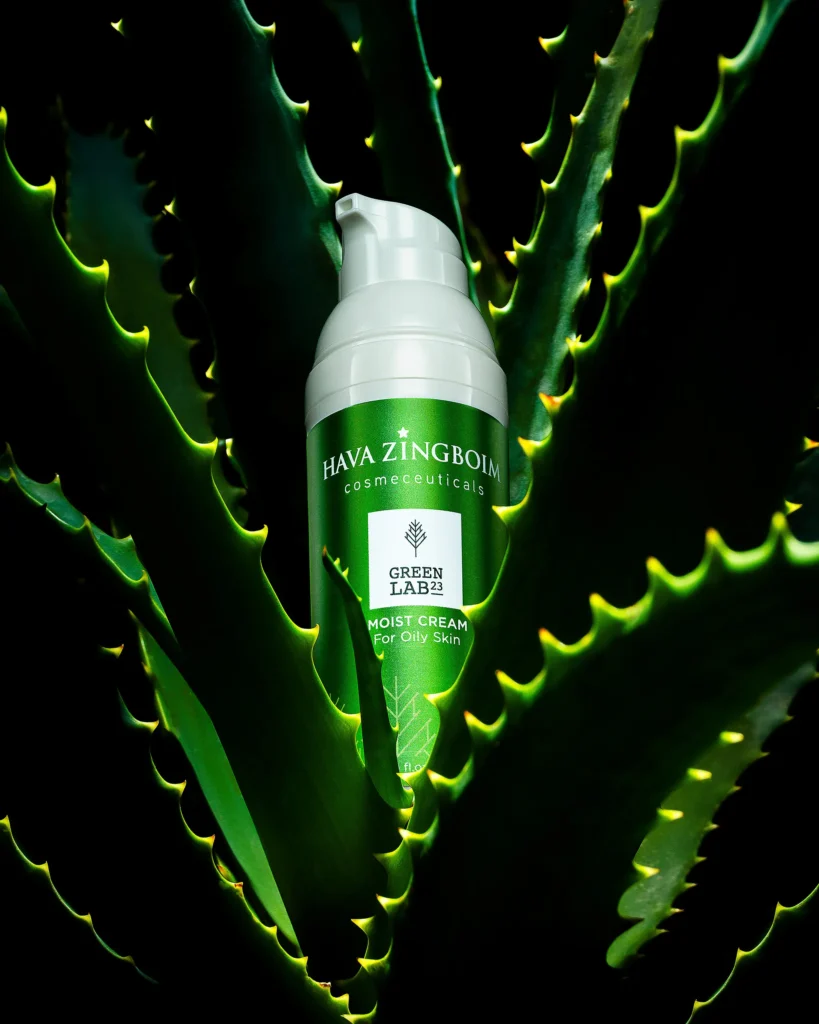 White pump bottle nested in backlit aloe leaves