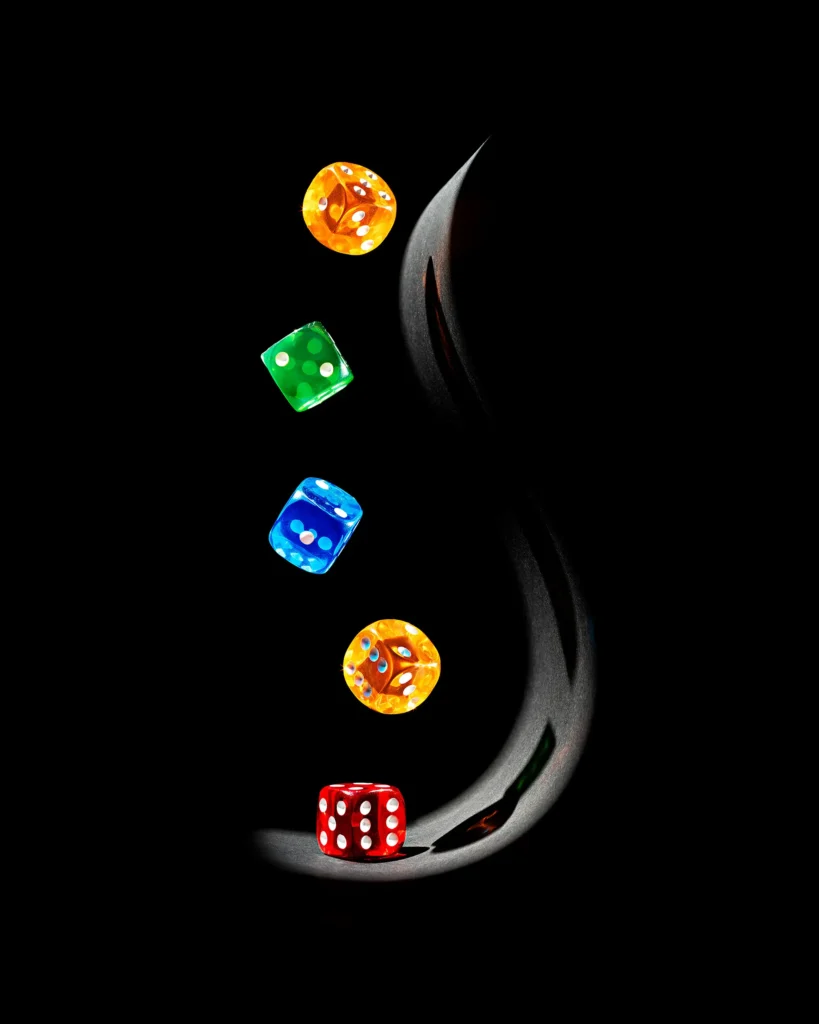 Coloured dice falling along a curved black form