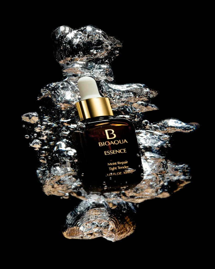 Amber dropper bottle held in a burst of splashing water