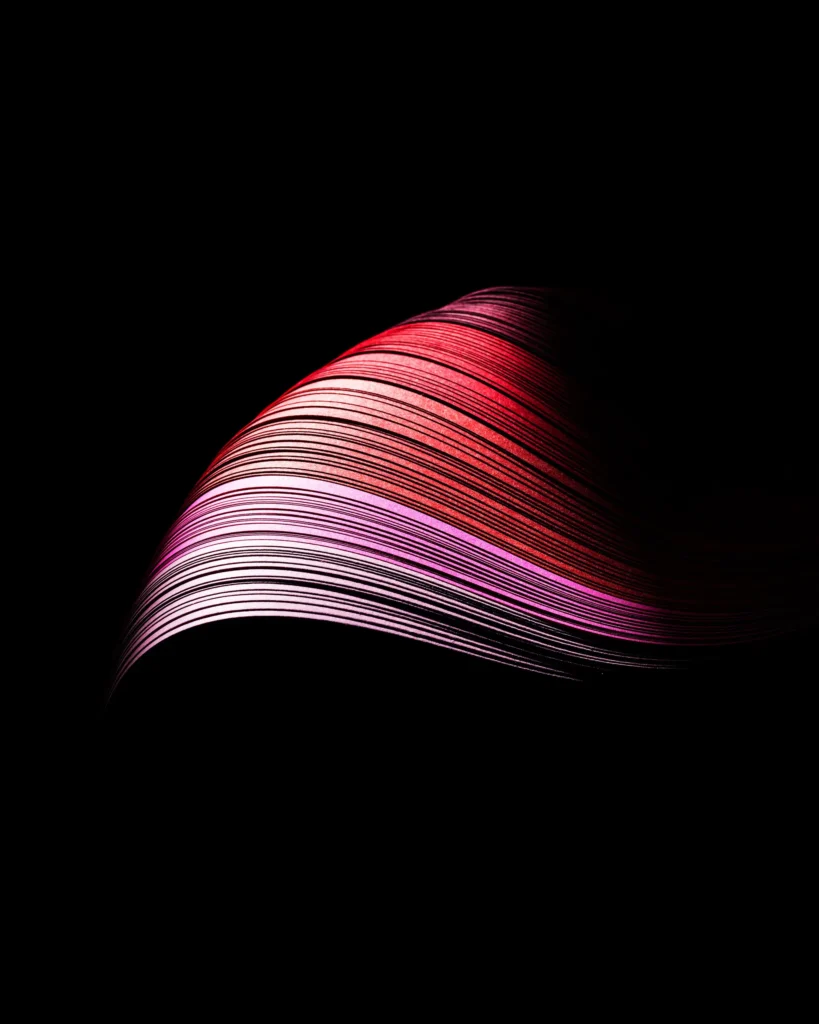 Sweep of mascara drawn as a fan of fine pink and white lines