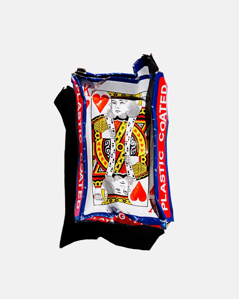 Crushed playing-card wrapper flattened on white