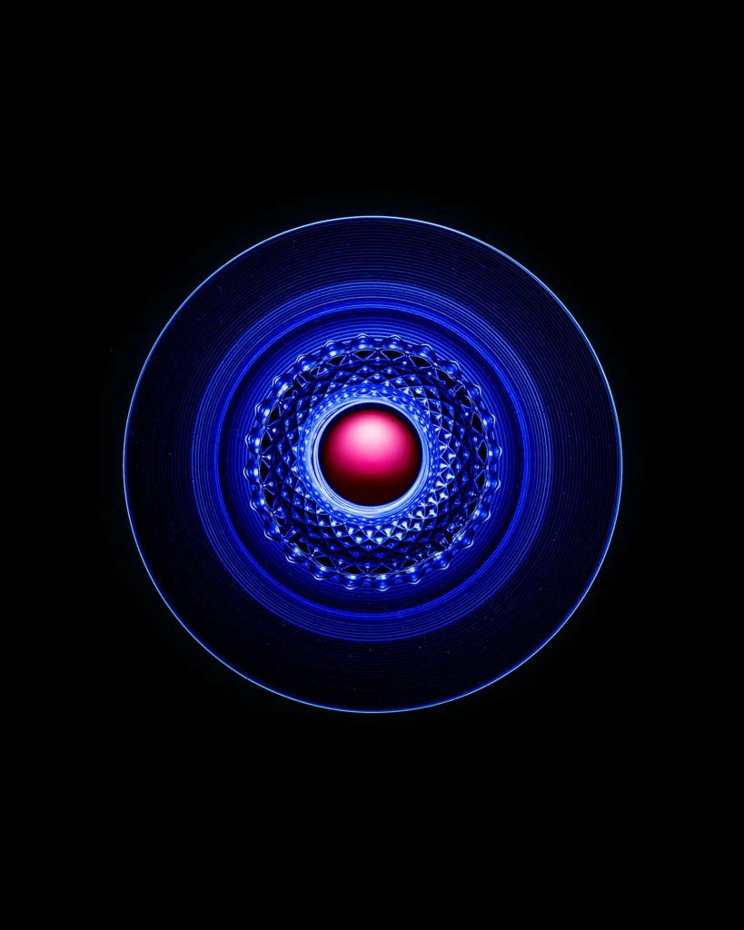 Concentric blue rings around a small pink sphere