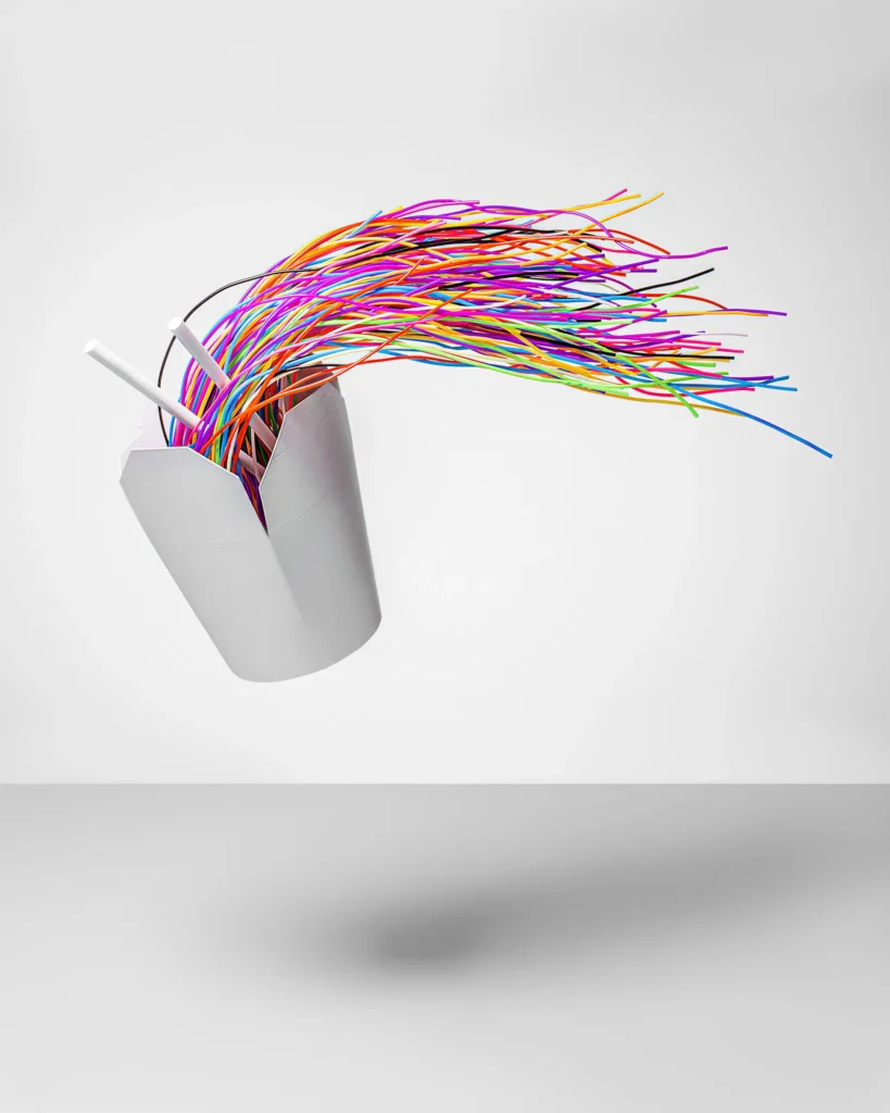 Coloured drinking straws spraying from a white cup