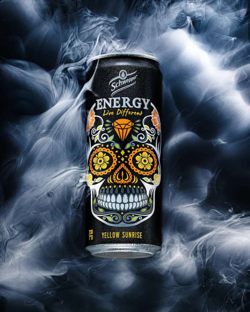 Energy drink can with skull artwork in swirling smoke