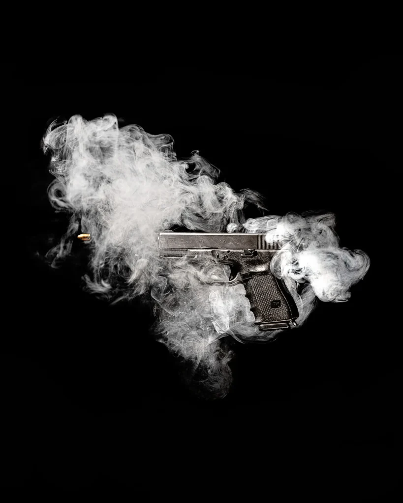 Pistol wrapped in a cloud of white smoke