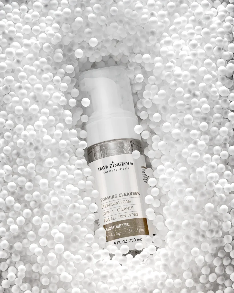 White pump bottle set into a bed of white beads