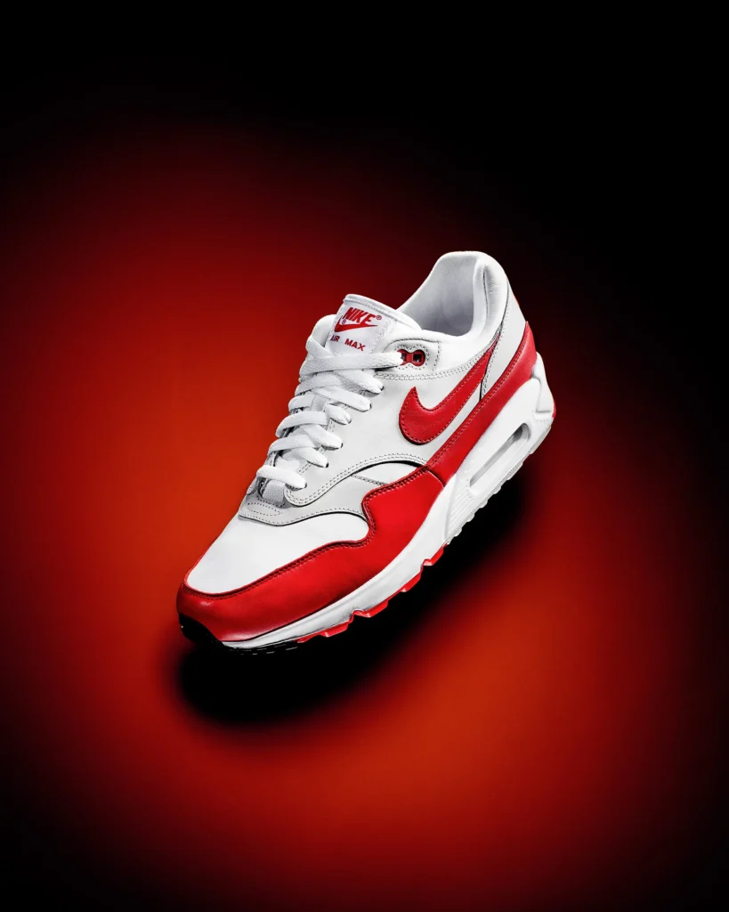 Red and white trainer on a glowing red ground