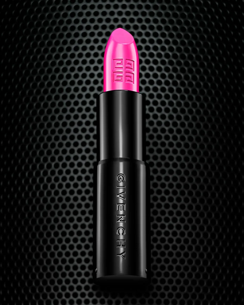 Pink lipstick in a black case on a perforated metal grid (retouched)