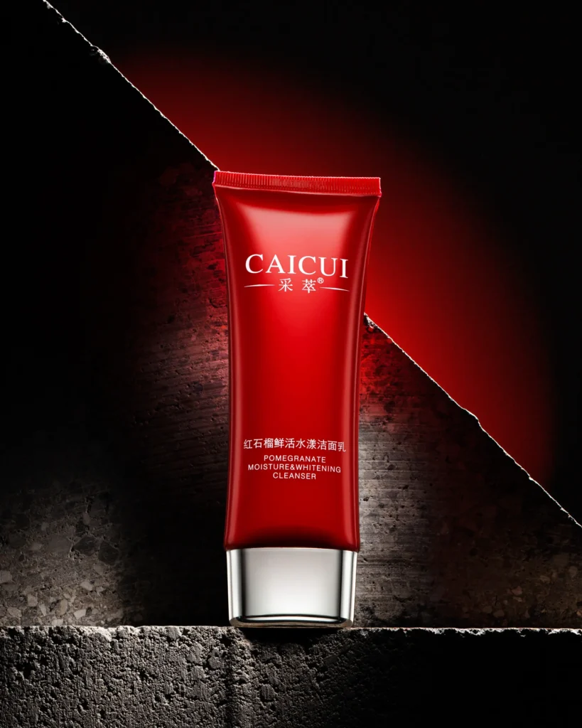Red cleanser tube standing against split stone (retouched)