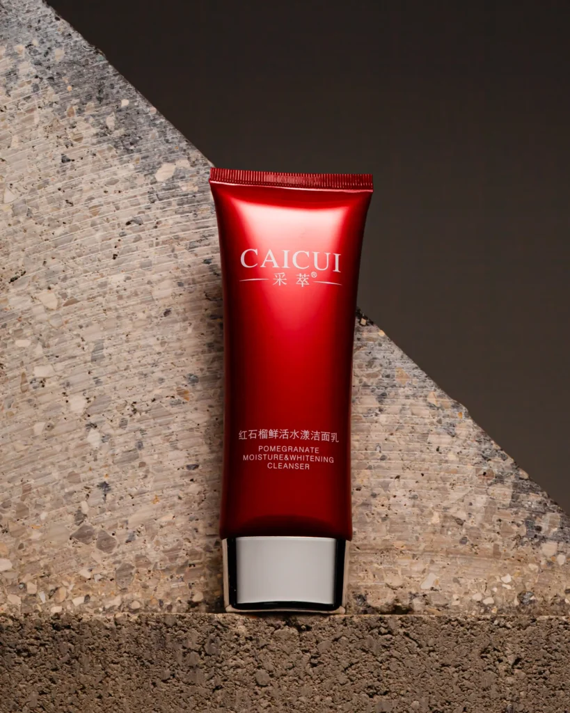 Red cleanser tube standing against split stone (unretouched original)