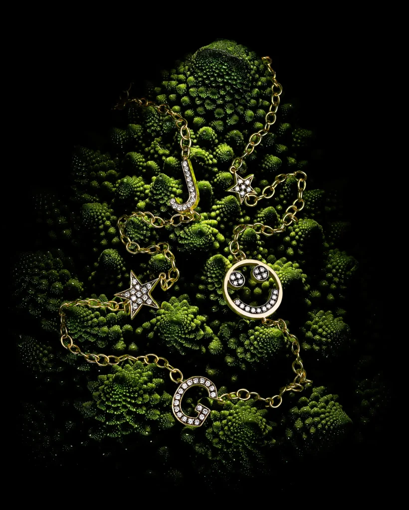 Gold charm chain laid over green romanesco florets (retouched)