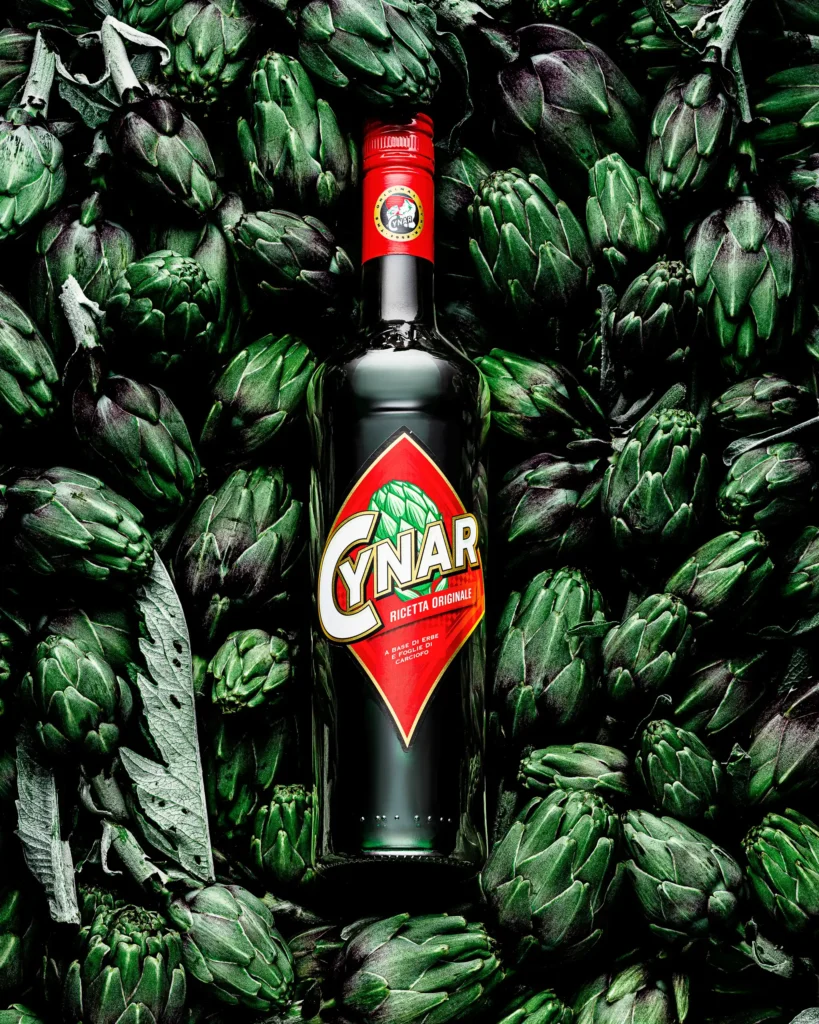 Herbal aperitif bottle centred in a bed of artichokes (retouched)