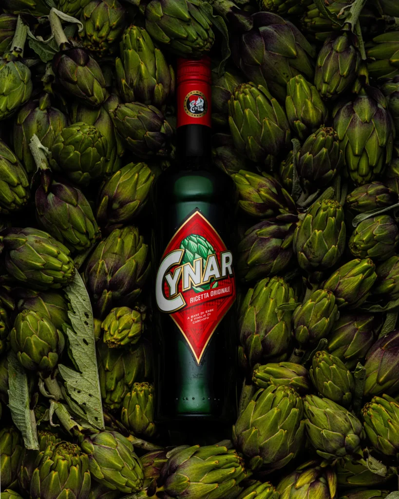 Herbal aperitif bottle centred in a bed of artichokes (unretouched original)